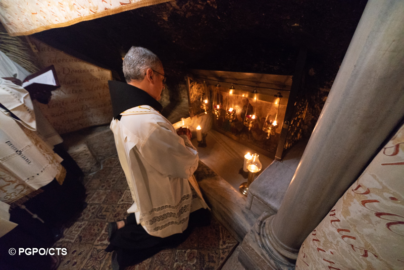 The Minister General of the Franciscan Friars Minor Fr. Massimo Fusarelli praying in the Nativity Grotto