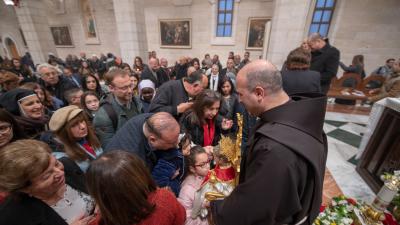 Epiphany 2020: parishioners of St. Catherine's in Bethlehem venerate the statue of Baby Jesus, held up by parish priest Br. Rami Asakrieh